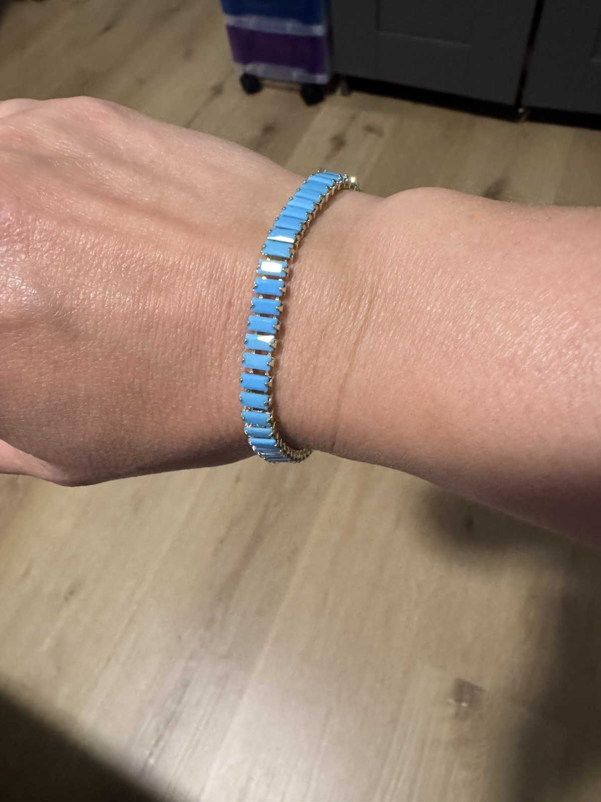 Metal link bracelet and necklace in blue and gold tones with a box clasp.
