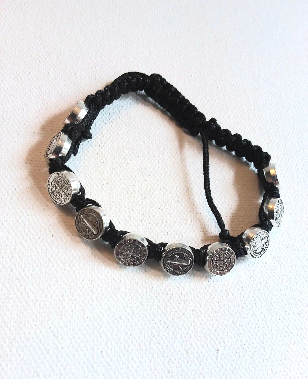St. Benedict Adjustable Cord Bracelet with 10 Metal Disks. Wrists 6.5″ – 8″