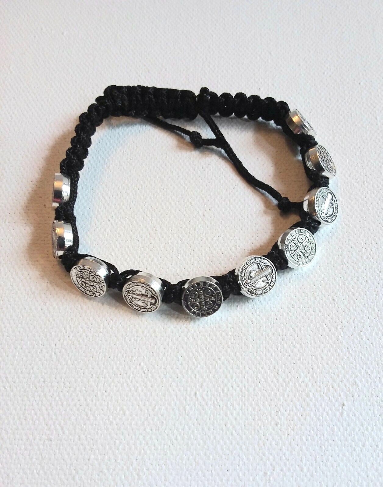 St. Benedict Adjustable Cord Bracelet with 10 Metal Disks. Wrists 6.5″ – 8″
