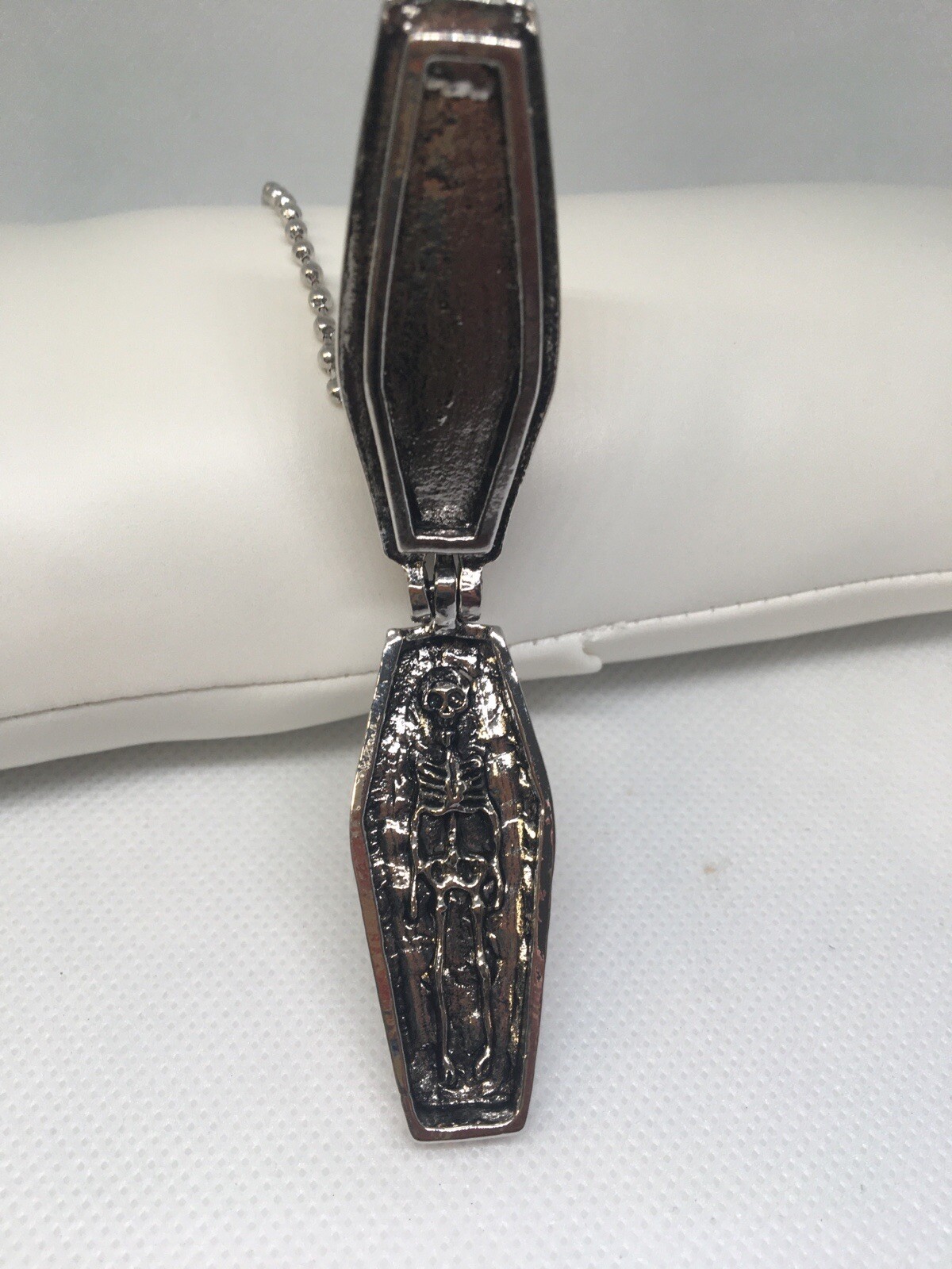 Feeling ghoulish? This coffin necklace is for you. Opens to skeleton remains.