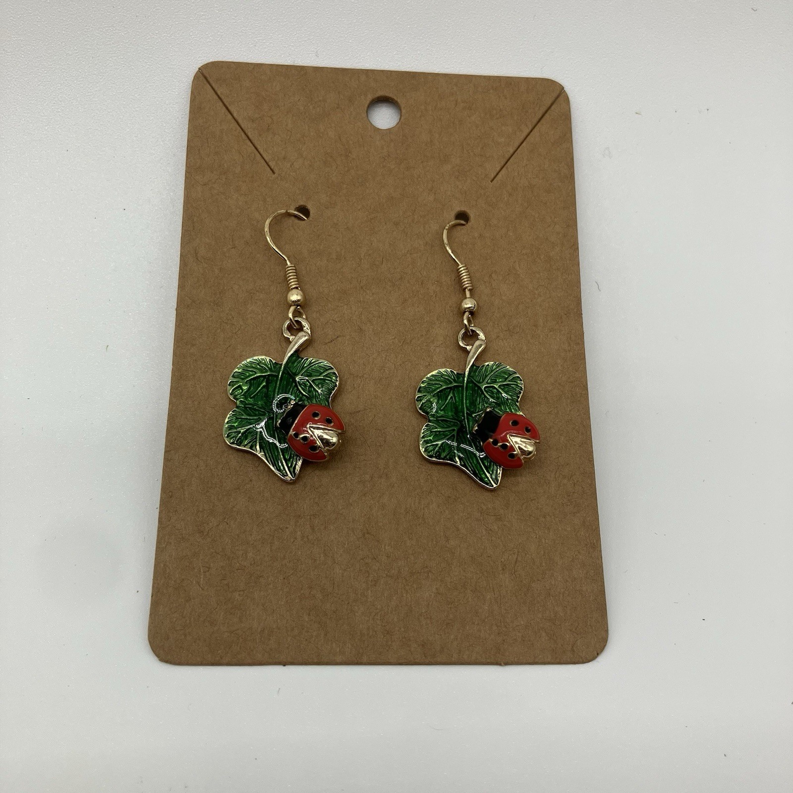 Leaf Earrings with Red Ladybug in a Green Shiny Enamel in gold plating
