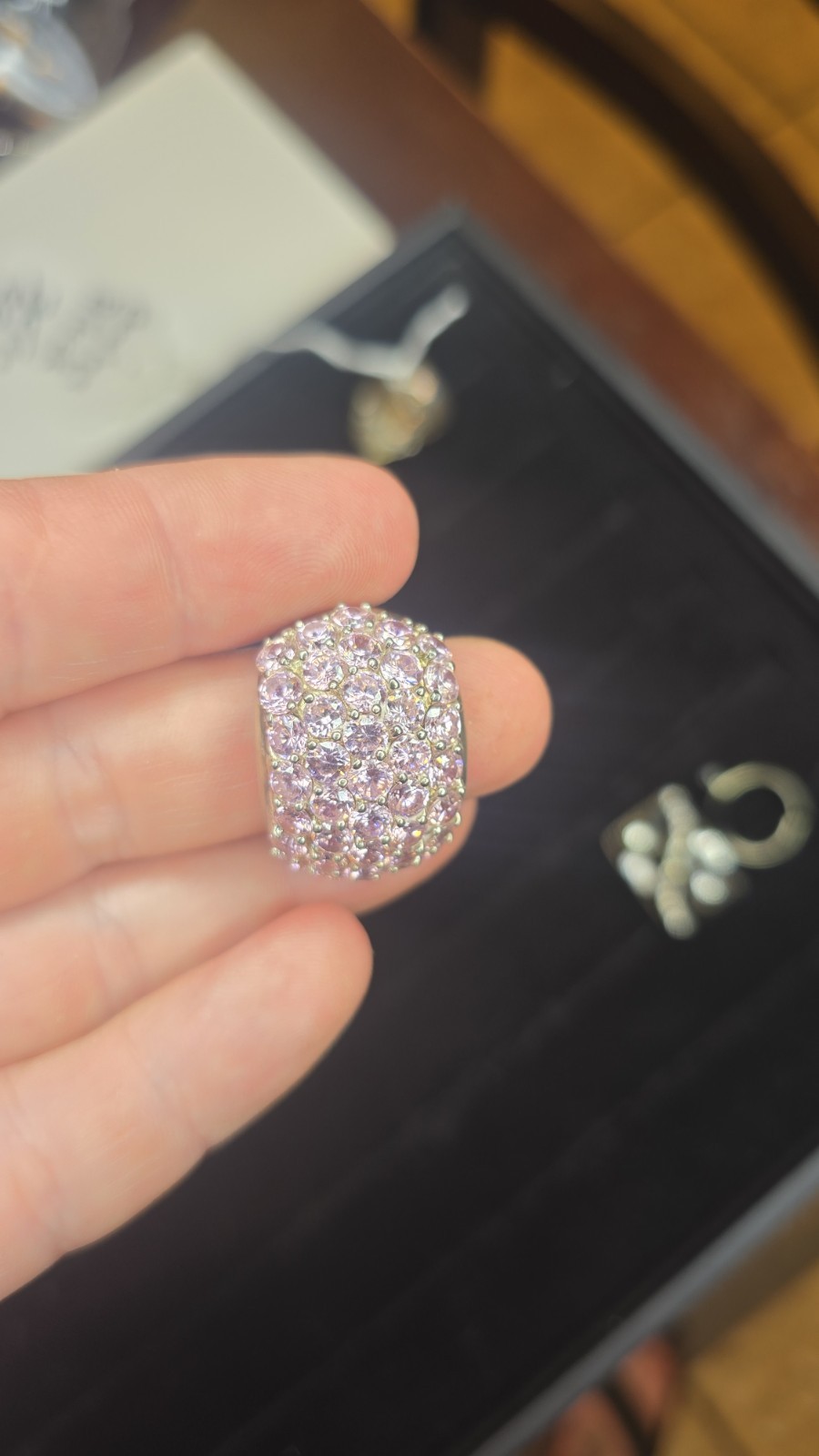 Wide Ring pavé setting of pink gemstones, likely sapphires or cubic zirconia
