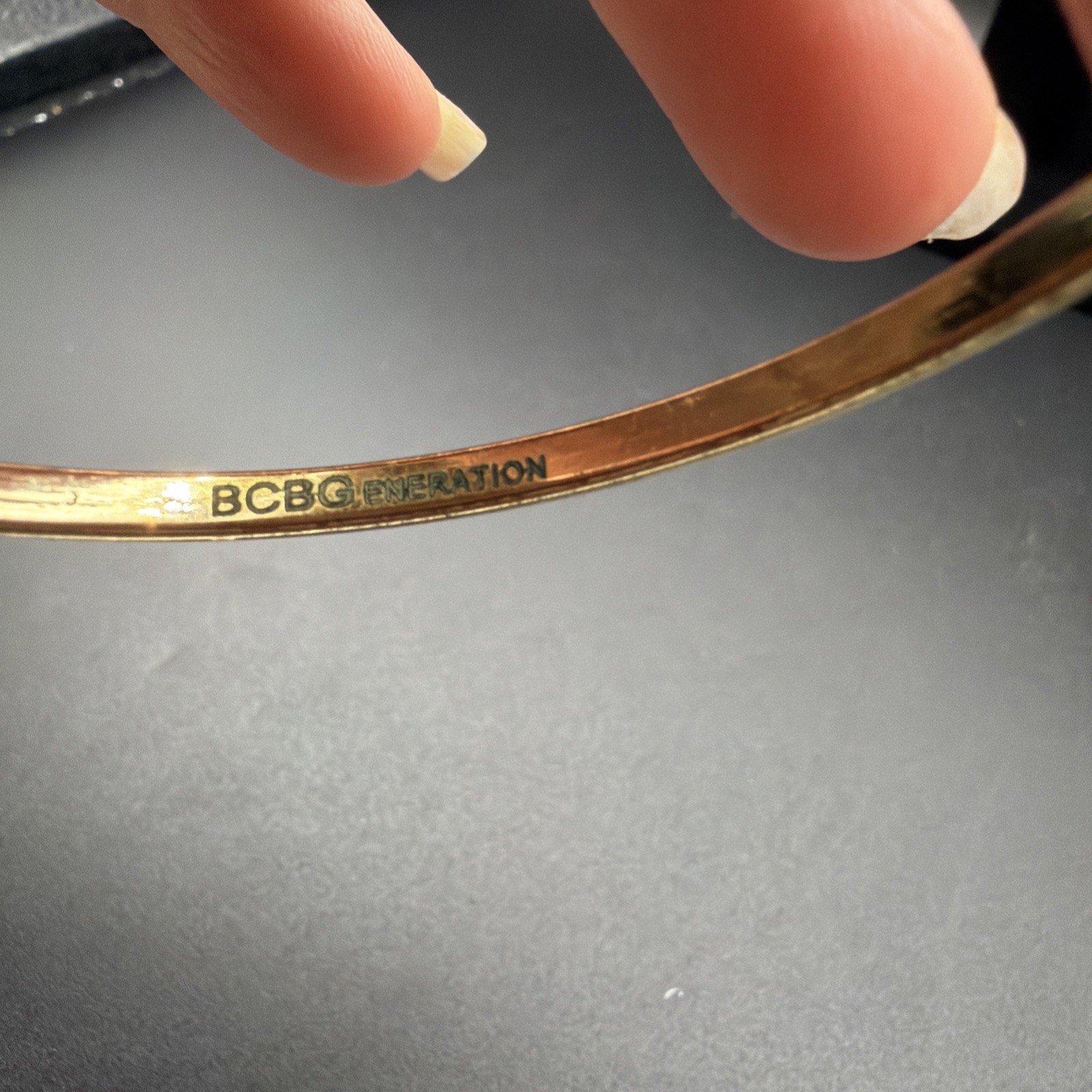709. BCBGeneration “R” Bracelet With Tassle Gold Tone