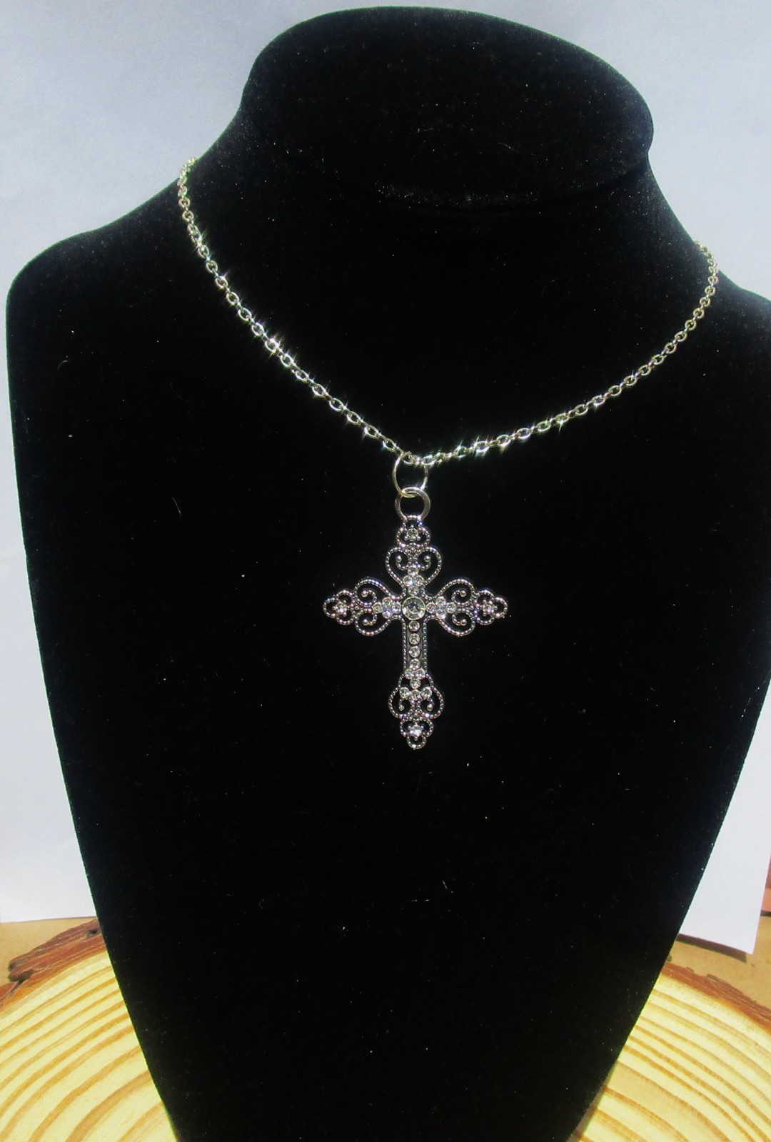 silver color ornate cross necklace for women