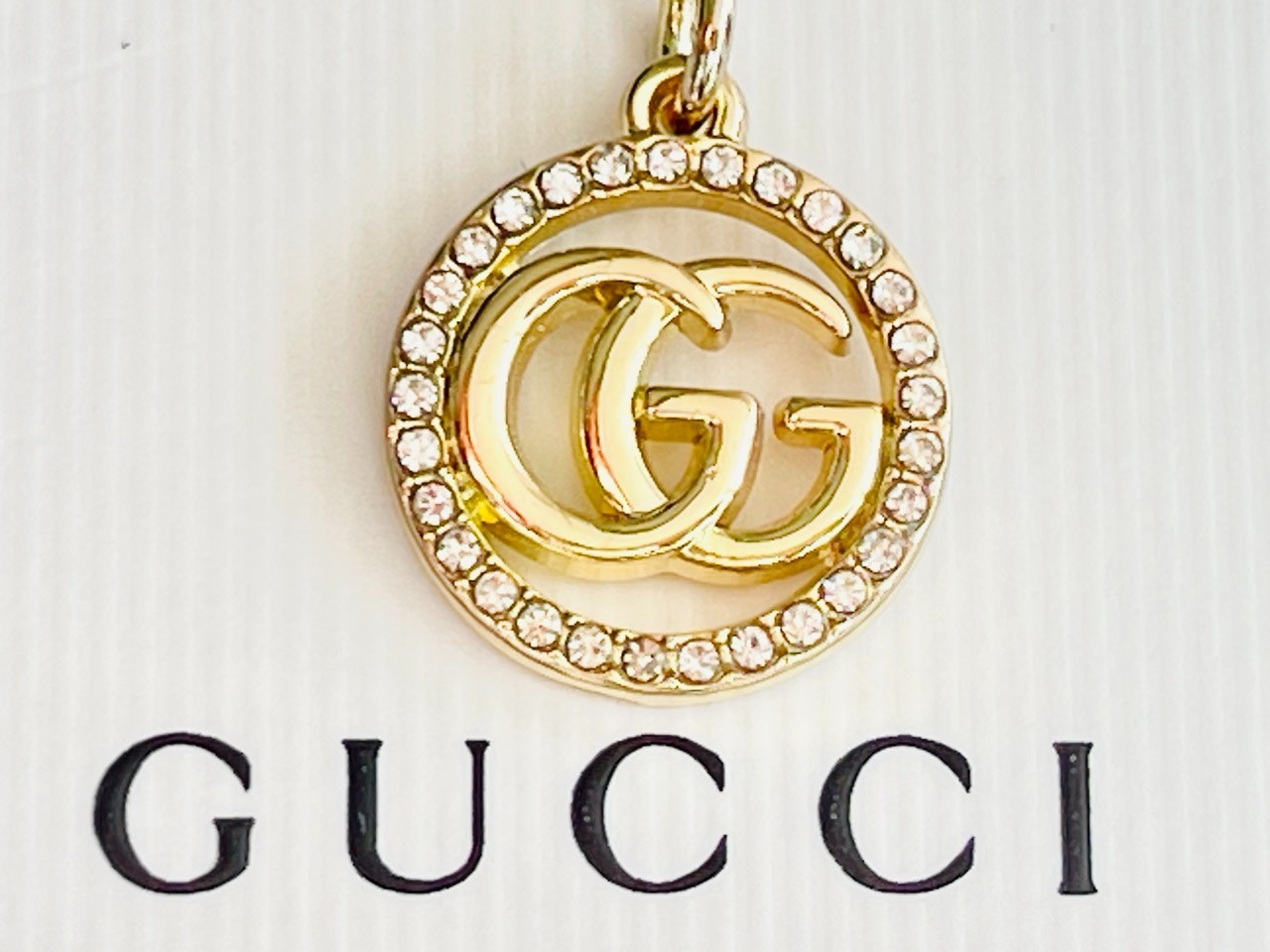 One Gucci Pendant rinestones stamped