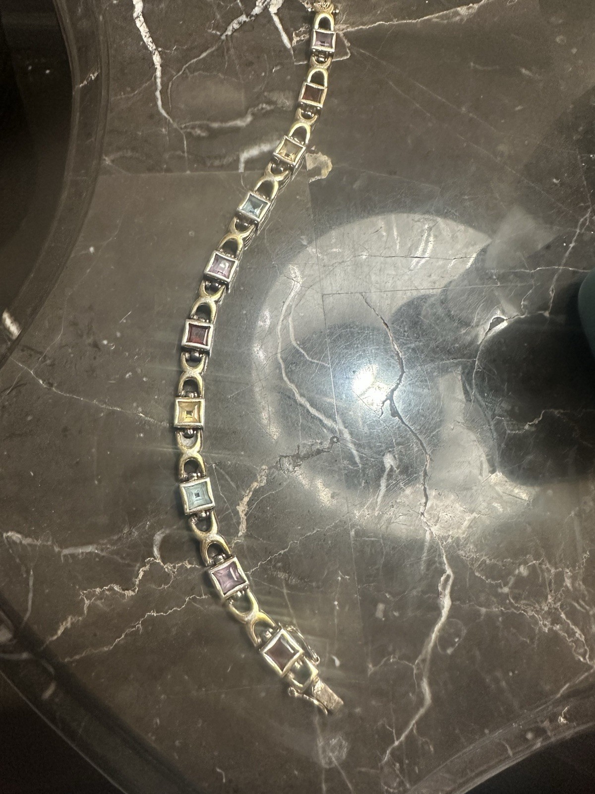 Gold Plated link bracelet with assorted square gemstones and a bezel box clasp.