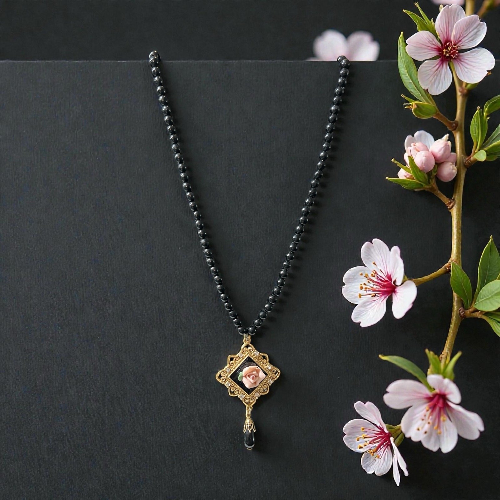 Vintage 1928 Jewelry Co with Black Beads and Gold-tone Pendant w/Pink Rose