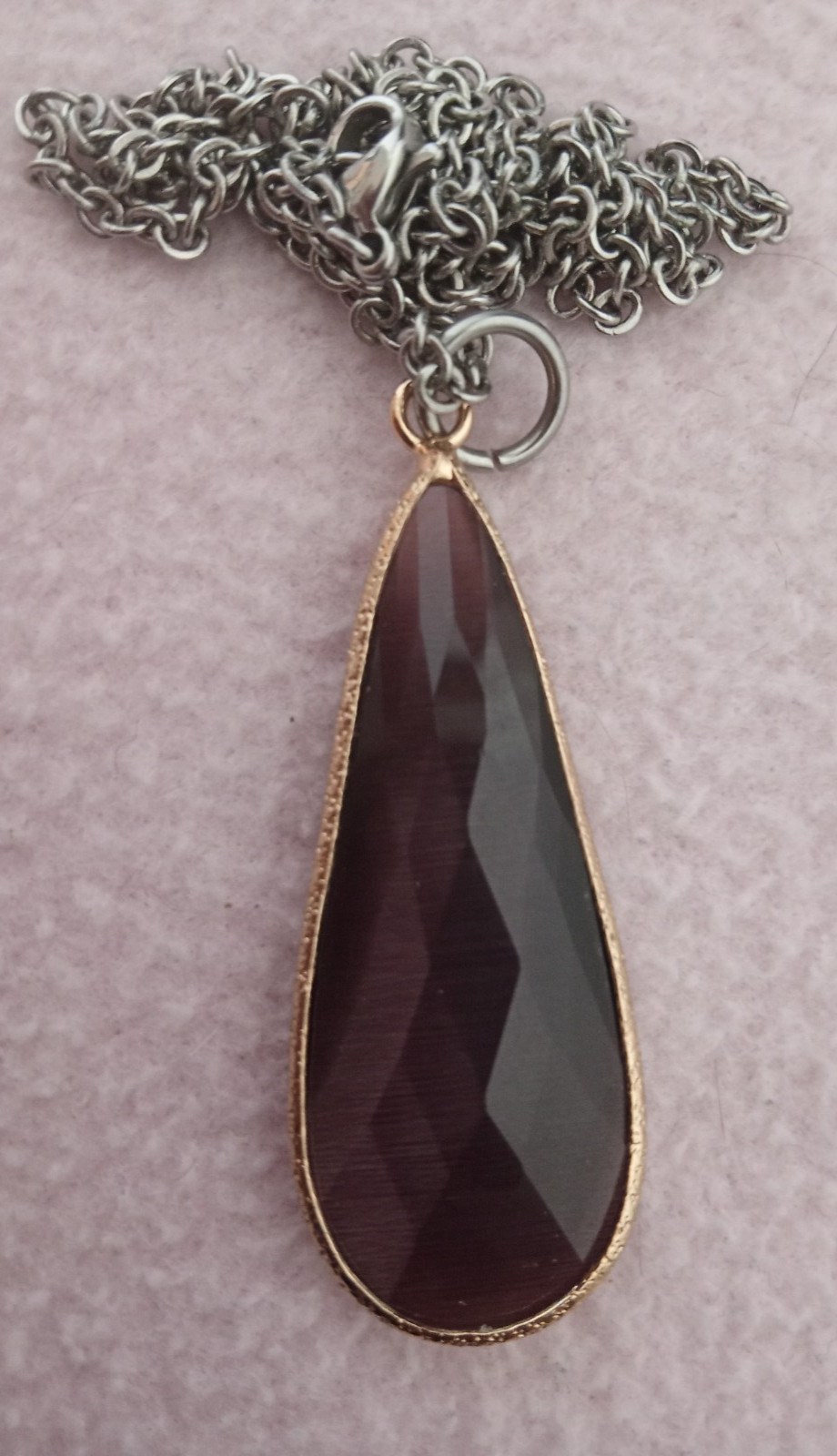 Faceted Purple Long Teardrop Stone Pentant framed in gold tone metal with chain