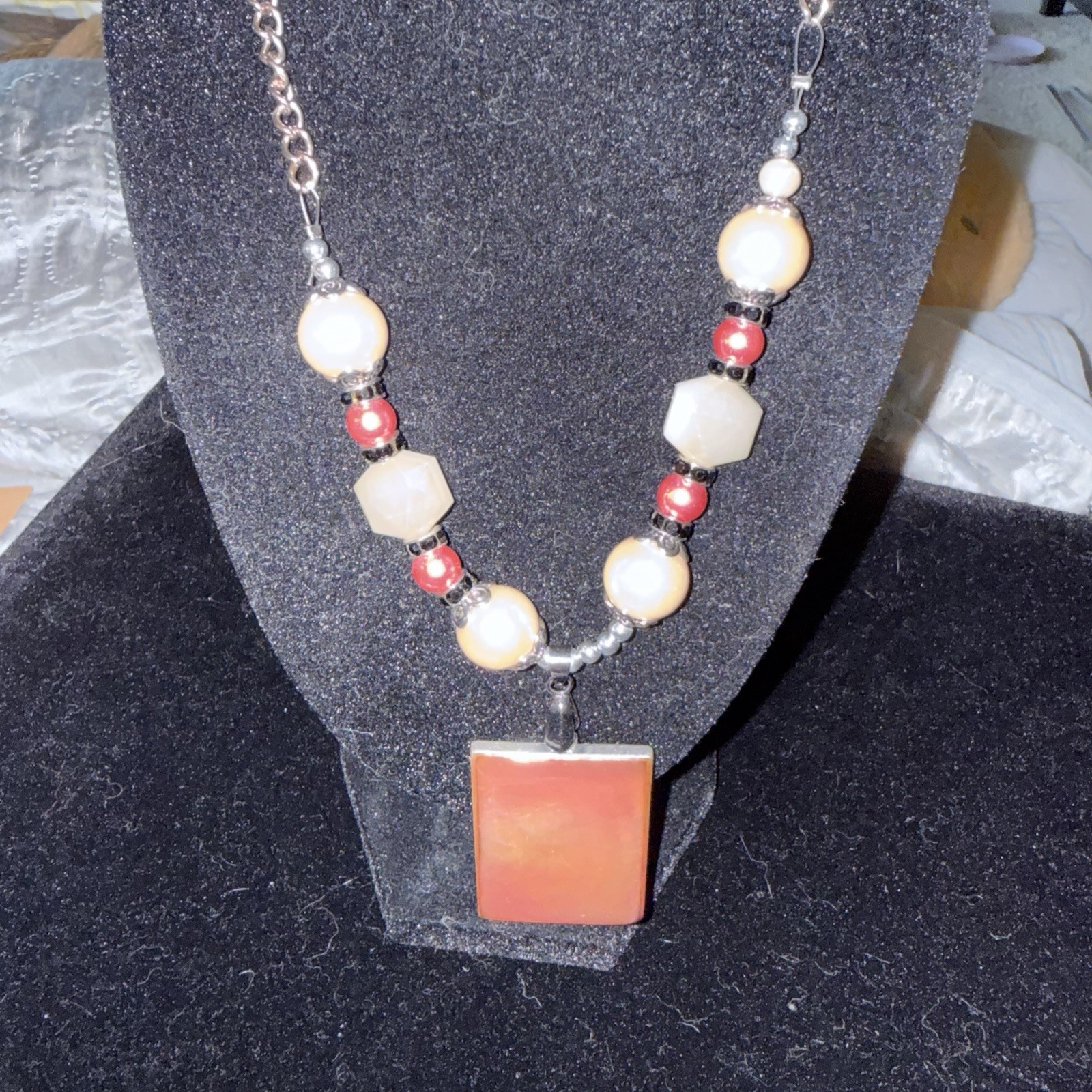 Silver tone red & white beaded necklace w/ orange rectangle charm, adjustable
