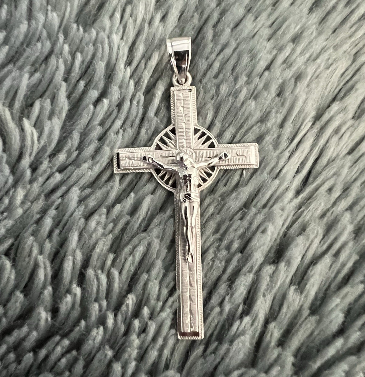 This 14k gold Saint Benedict cross pendant features a detailed Jesus crucifix