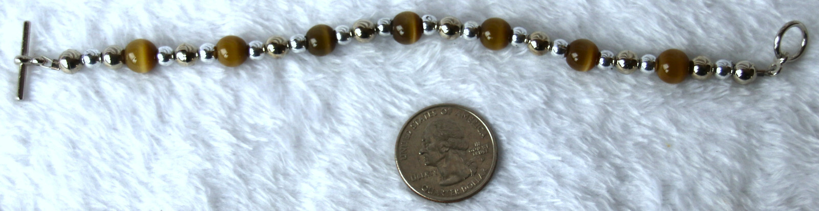 Bracelet of Brown Cat’s Eye Glass with silver colored beads, toggle closure