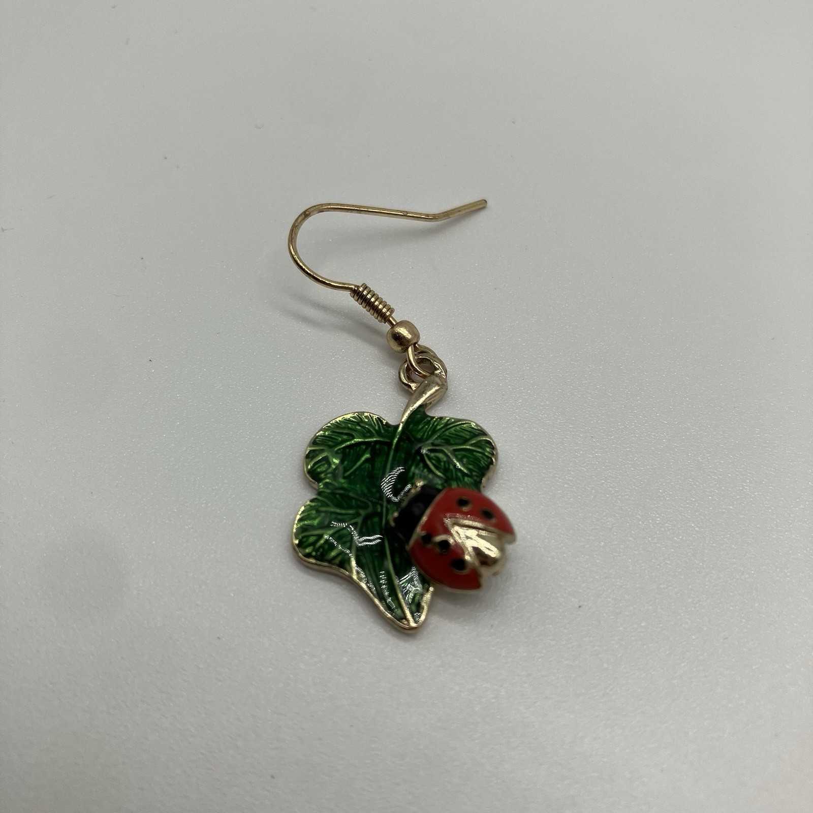 Leaf Earrings with Red Ladybug in a Green Shiny Enamel in gold plating