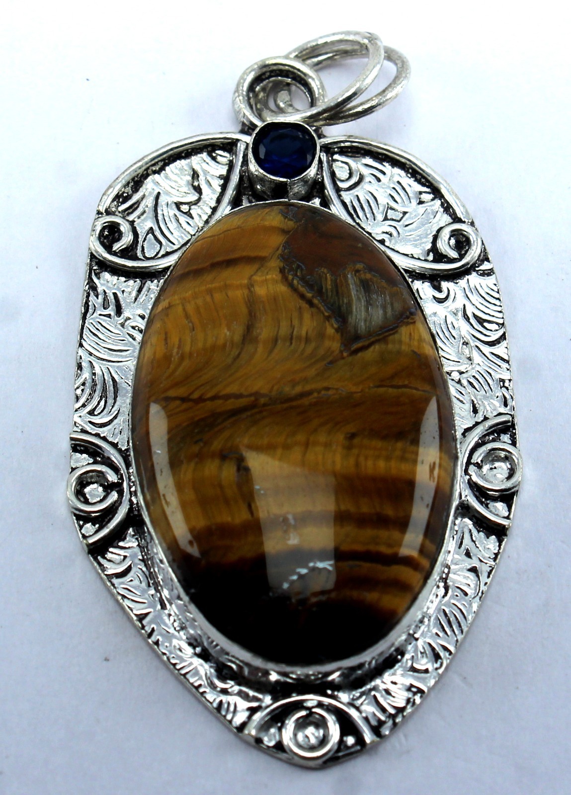 Handcrafted Sterling Silver Natural Tiger’s Eye Pendant – Blue Sapphire Accent