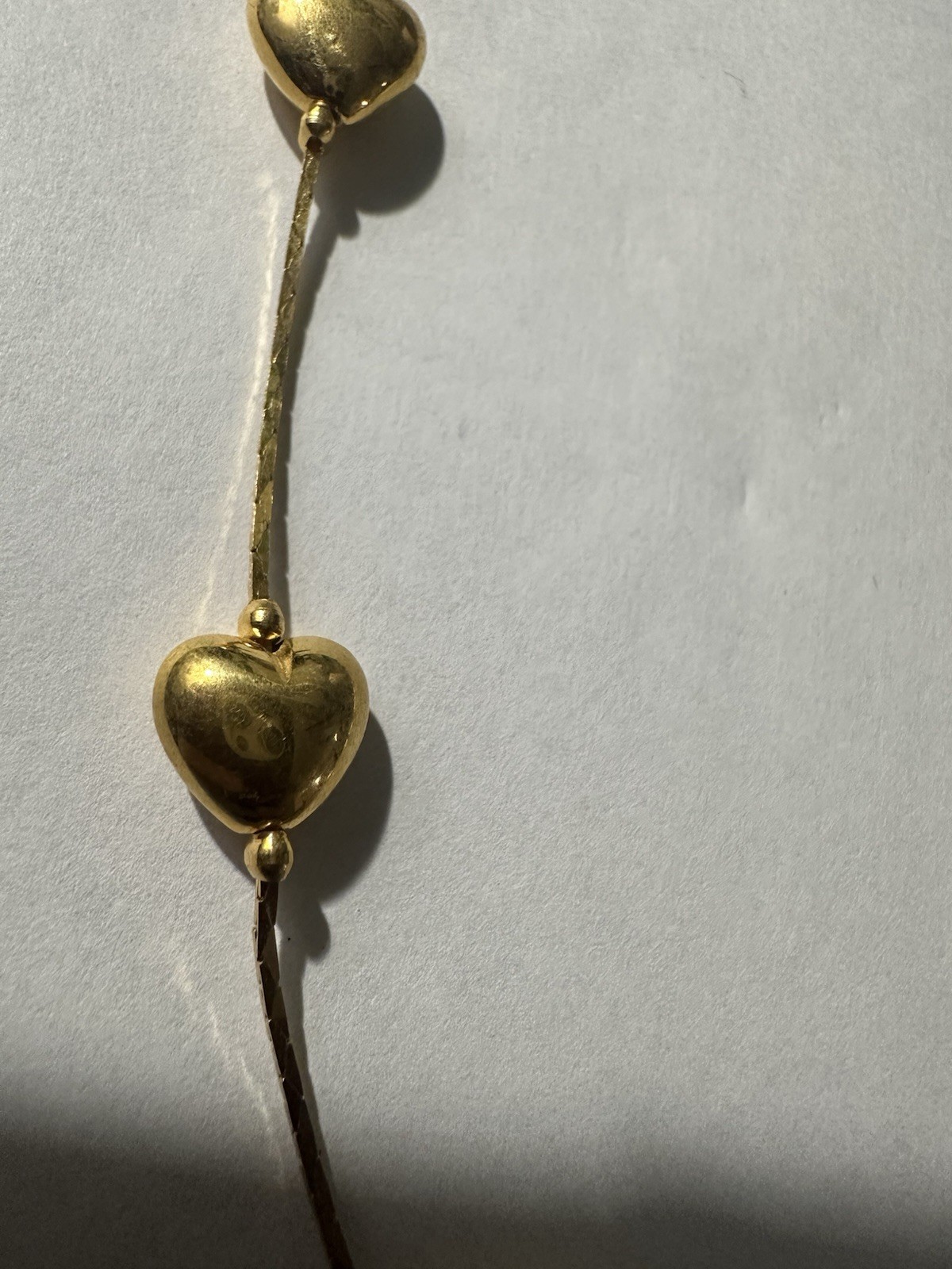 Trifari gold-tone chain features multiple stationed puffy hearts