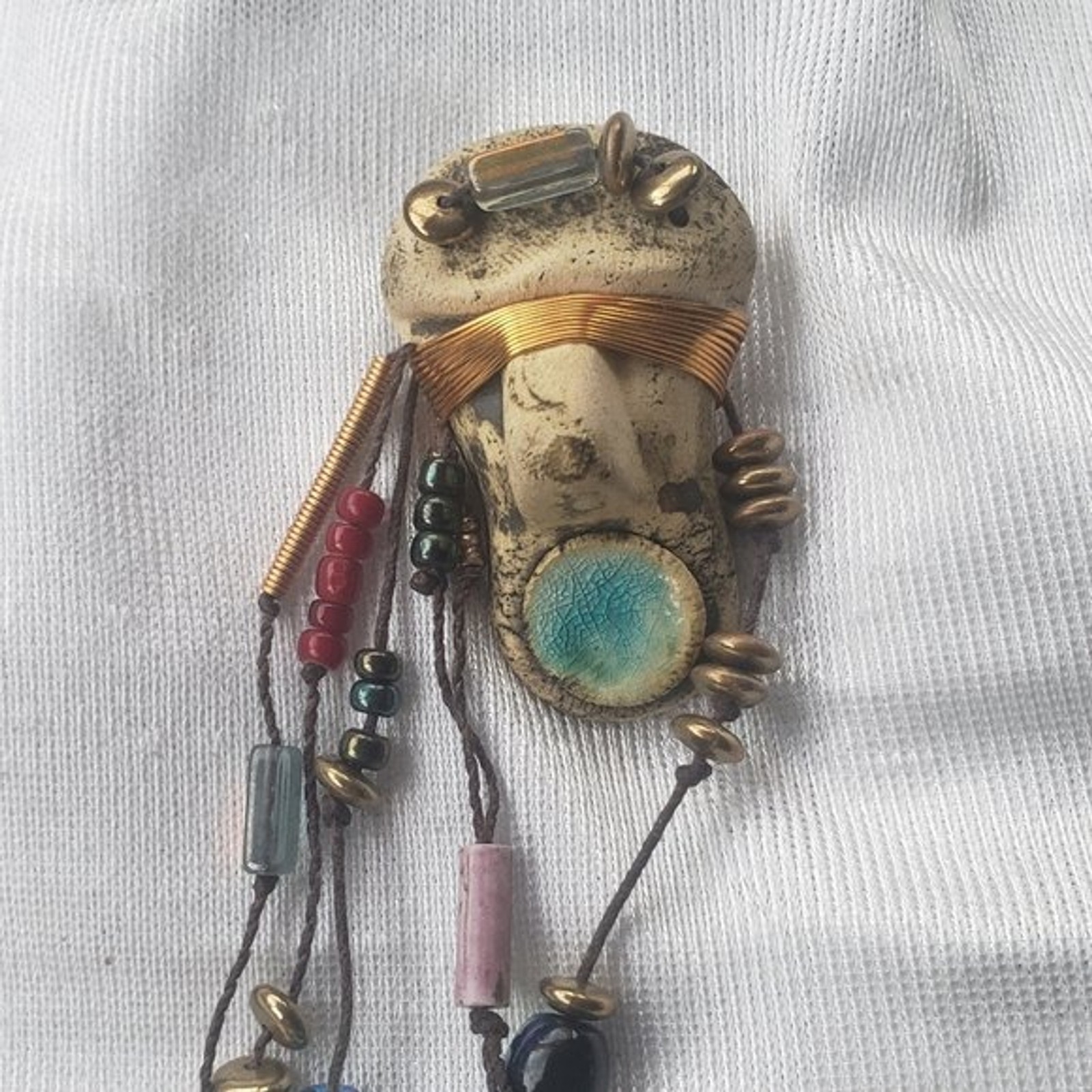 Abstract tribal brutalist face with locs like hair artisan brooch