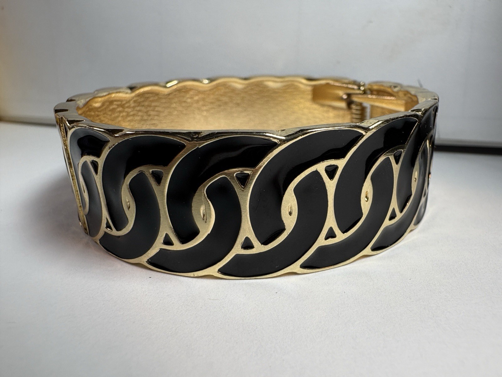 Bold and modern hinged cuff bracelet ,gold-tone with black enamel