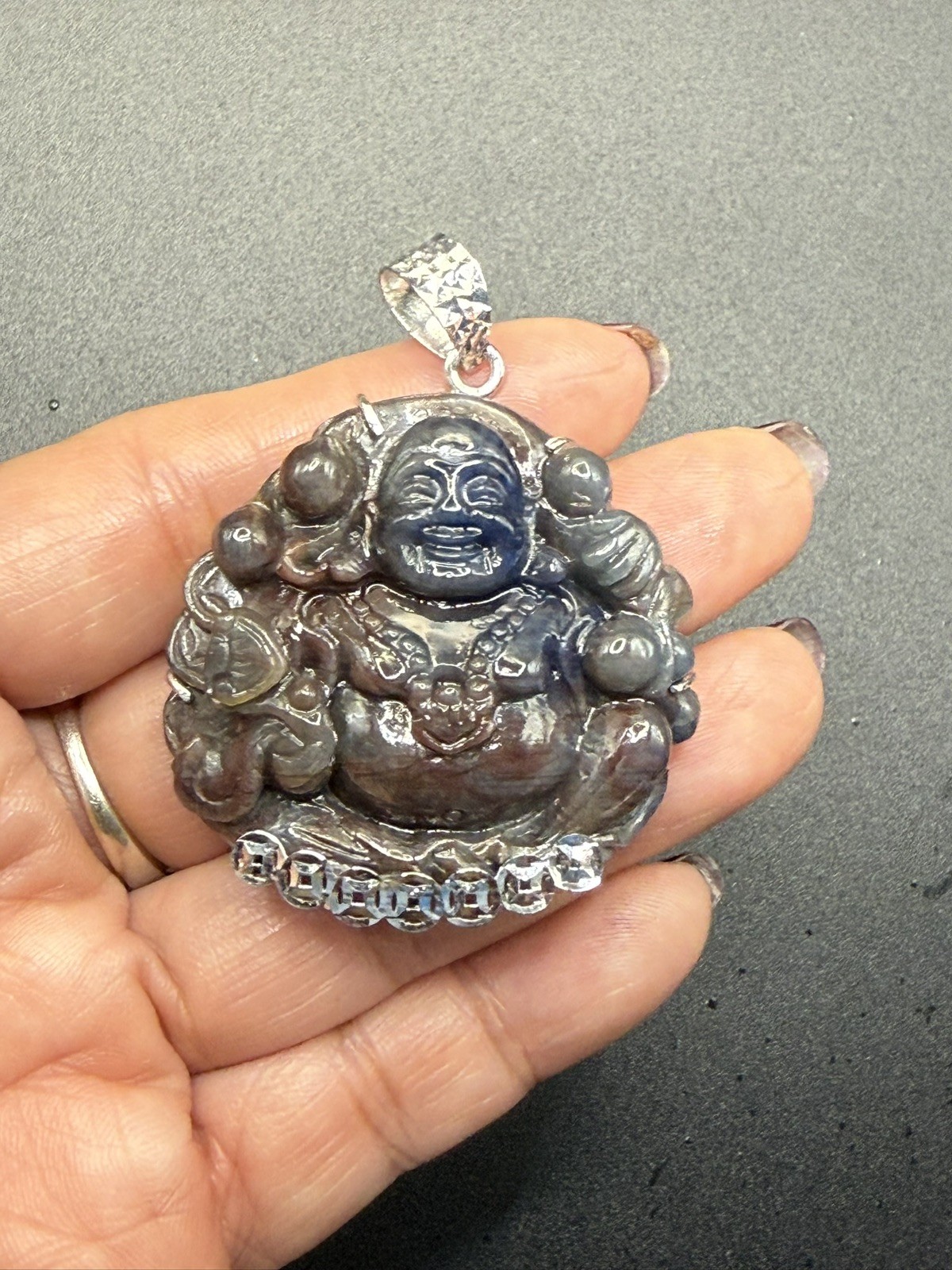 Maitreya Laughing Buddha100% Natural Saphia carved by hand. With Silver