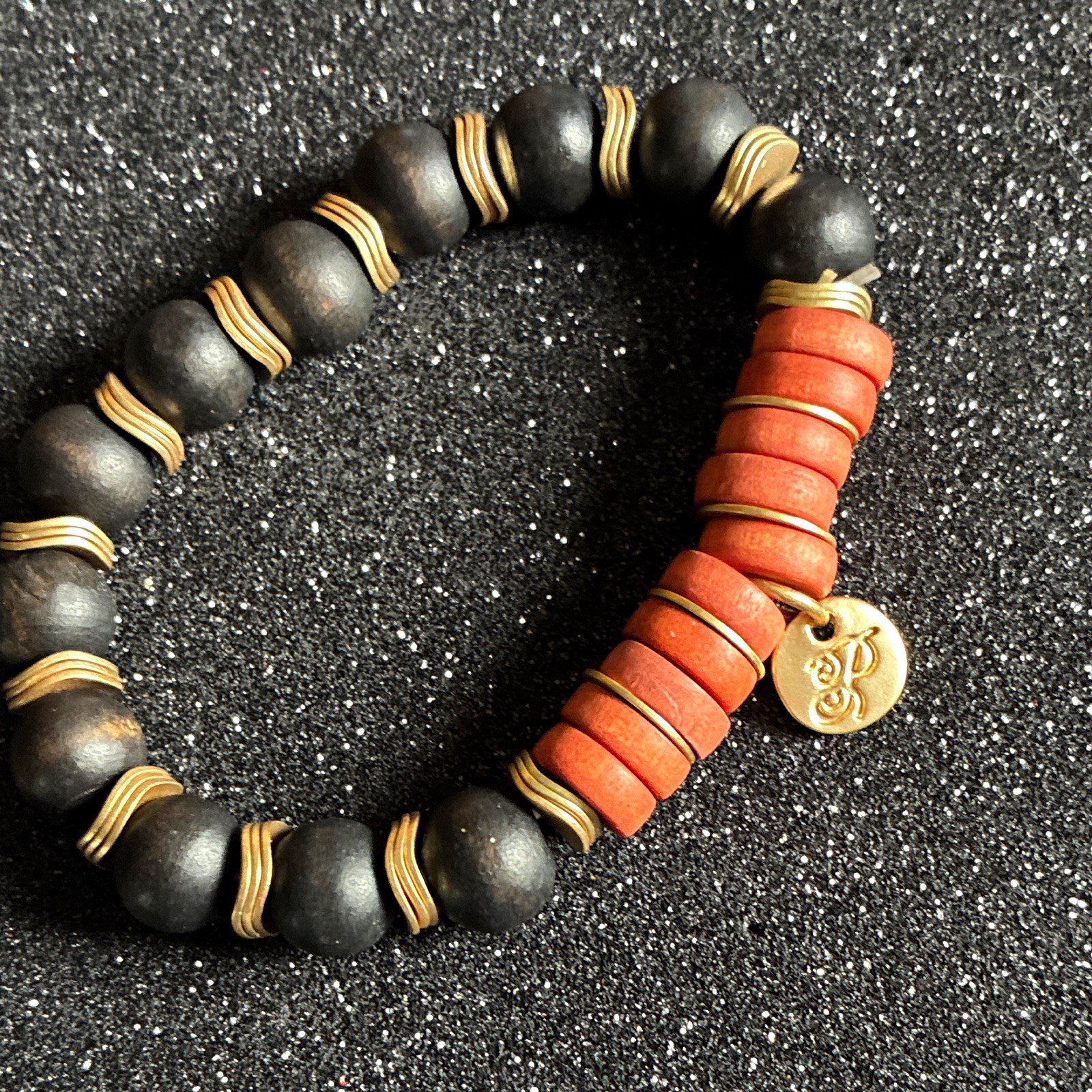 Beaded stretch bracelet black brown wood beads gold tone spacers dangle charm