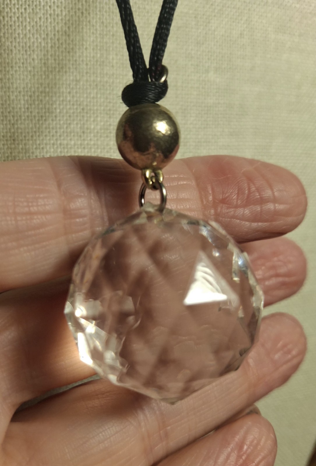 No brand glass or acrylic faceted clear ball w/black knotted cord necklace