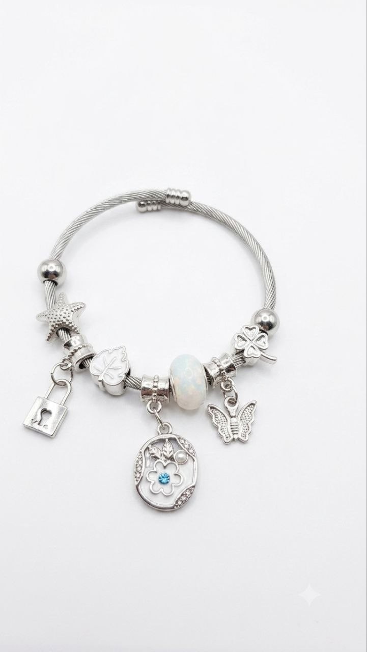 Beautiful silver-tone charm bangle bracelet featuring unique pendants and a gem