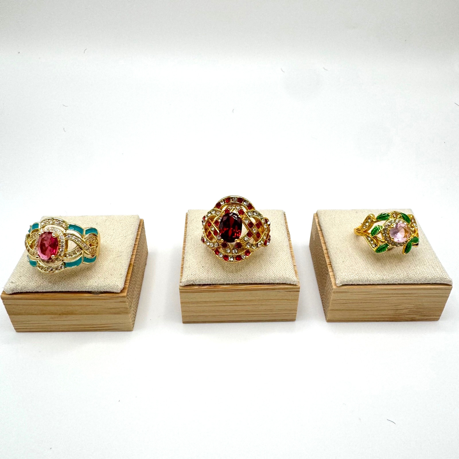Gold tone statement ring bundle with one central stone and ornate accent stones