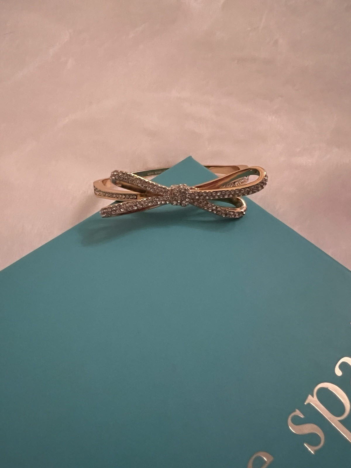 kate spade new york Gold Tone Bow Bangle Bracelet w/ Pavé White Crystal