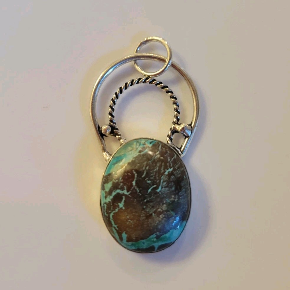 New 925 sterling silver pendant featuring an oval turquoise with Dark Matrix