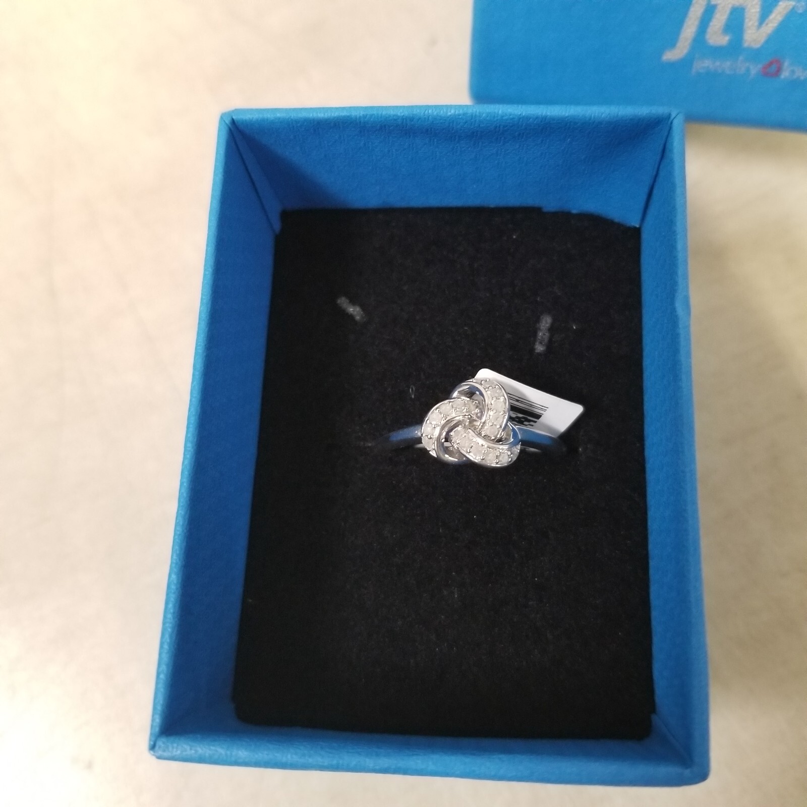 White Diamond Rhodium Over Sterling Silver Knot Ring 0.15ctw