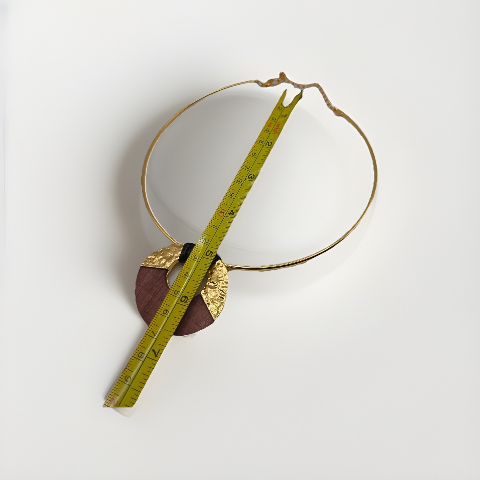 Gold-tone metal collar choker necklace with circular pandant
