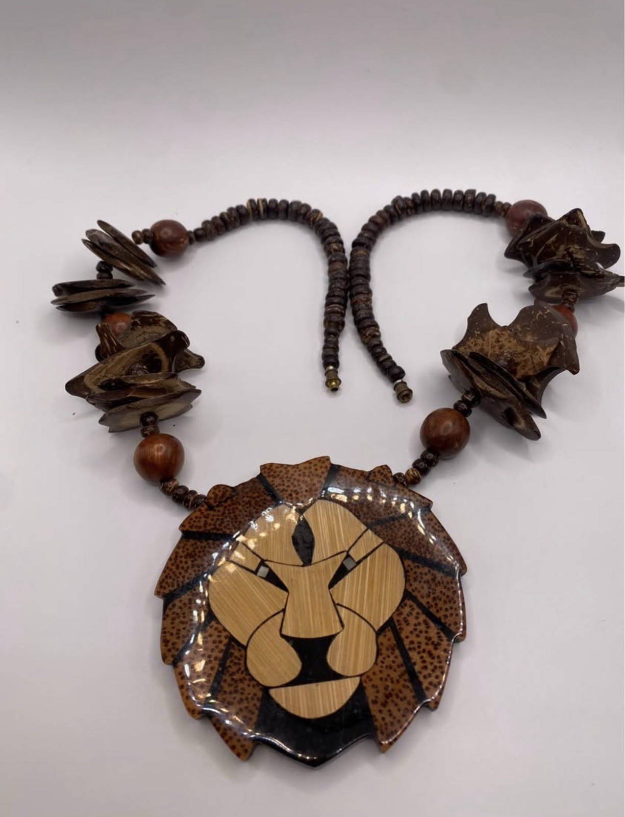 Wood Beaded Necklace by designer Lee Sands . Lion Face Animal Charm Pendant, by
