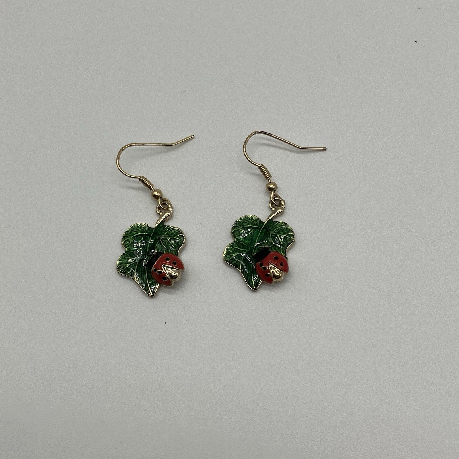 Leaf Earrings with Red Ladybug in a Green Shiny Enamel in gold plating
