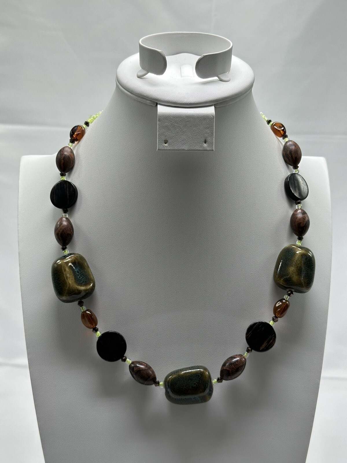 necklace with greens, blues, browns. glass, woods all of different shapes