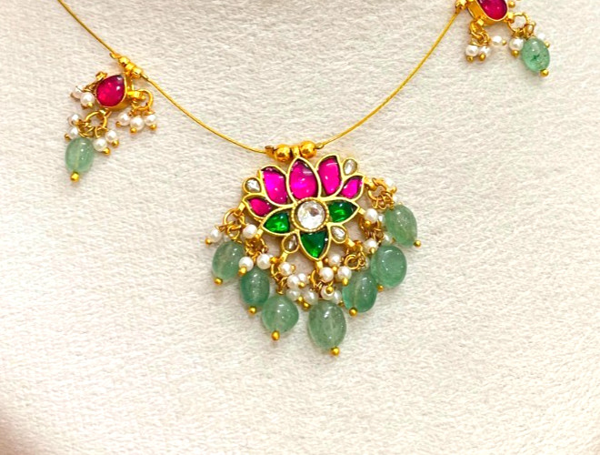 Brass jadau invisible necklace a central lotus pendant with pink and green stone