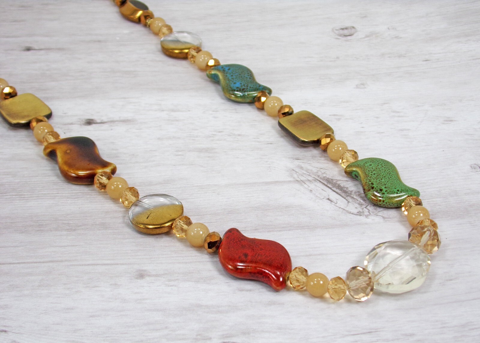 Multi color bead necklace with glass, ceramic, and metal beads, natural colors
