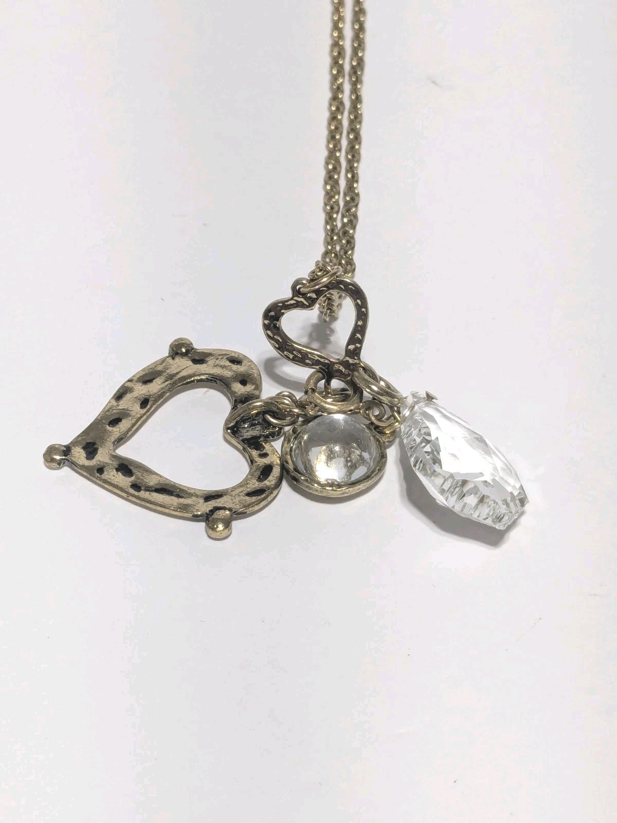 JM Marked Gold Tone Hammered & Embossed Charm Necklace With A Heart & Crystals.