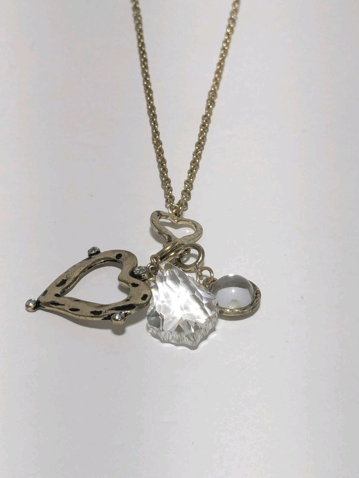 JM Marked Gold Tone Hammered & Embossed Charm Necklace With A Heart & Crystals.