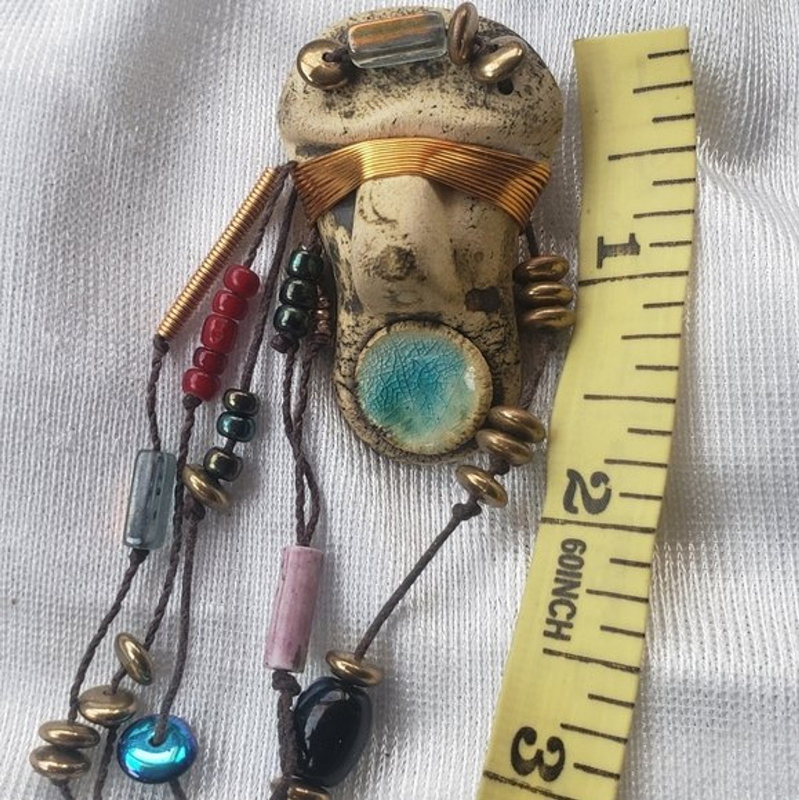 Abstract tribal brutalist face with locs like hair artisan brooch