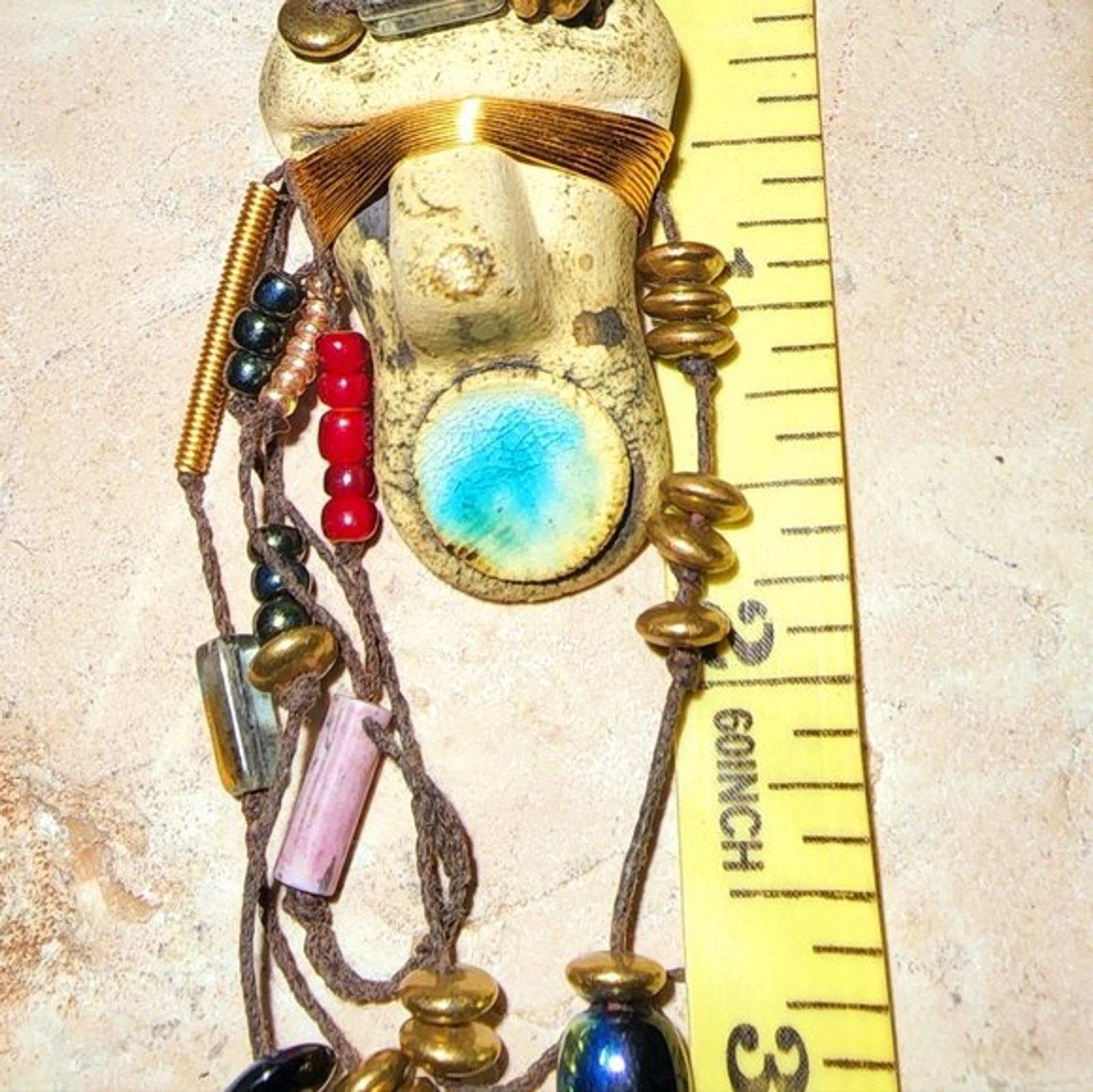 Abstract tribal brutalist face with locs like hair artisan brooch