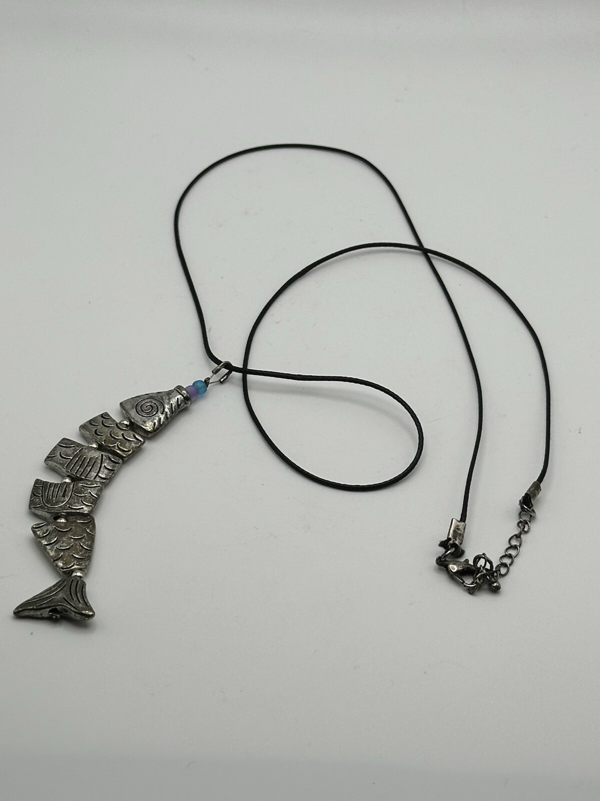 Six Segment Worry Fish Pendant On 24” Nylon Necklace With Lobster Clasp