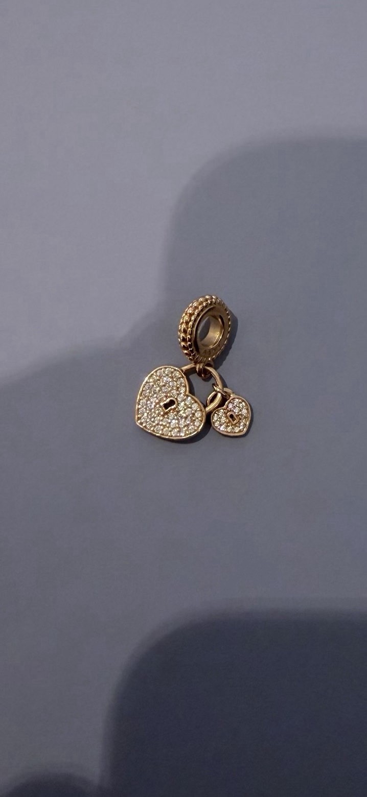 Pandora rose gold double heart lock dangling diamond charm.