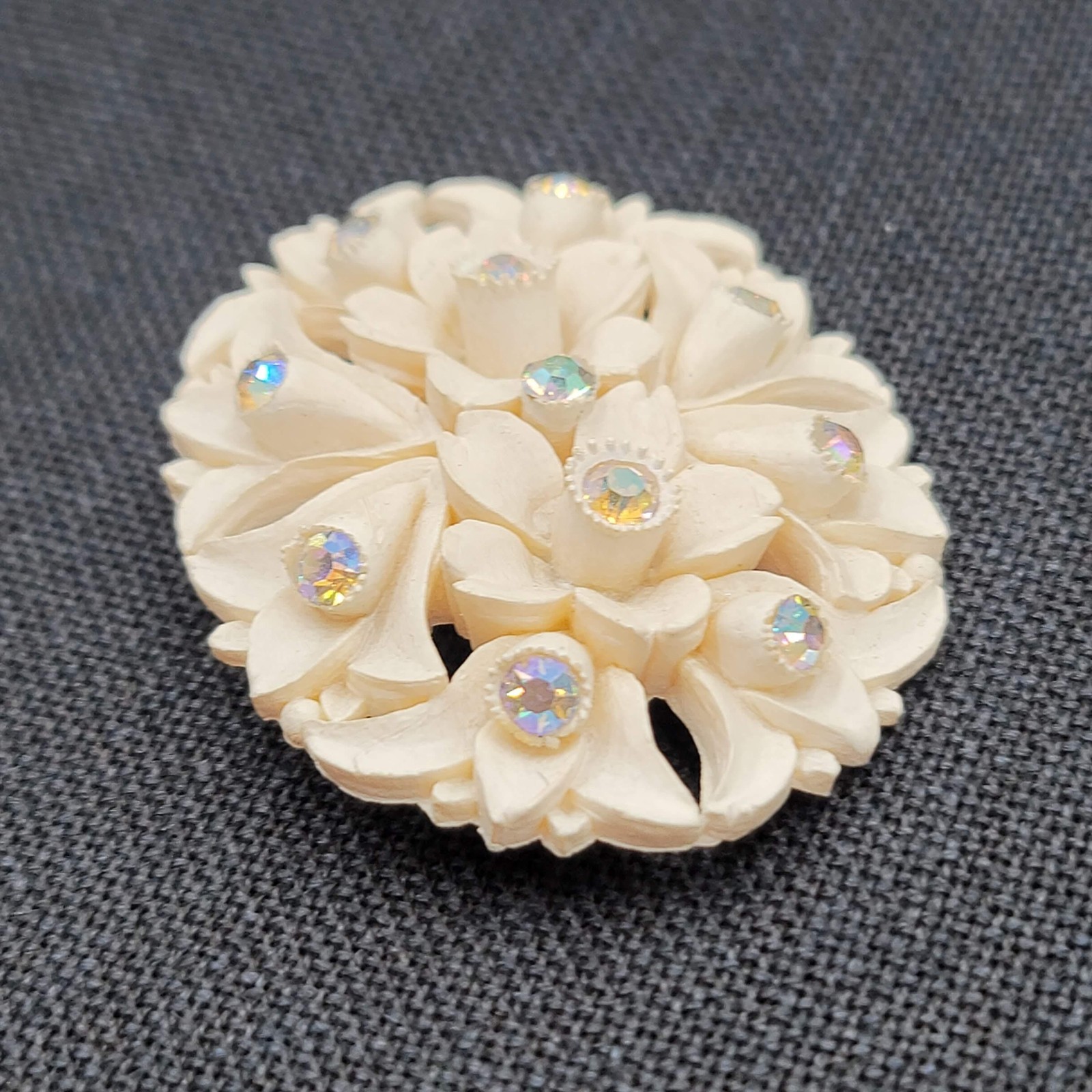 White Molded Flower Brooch Pin Aurora Borealis Rhinestone Oval Early Plastic 2.5