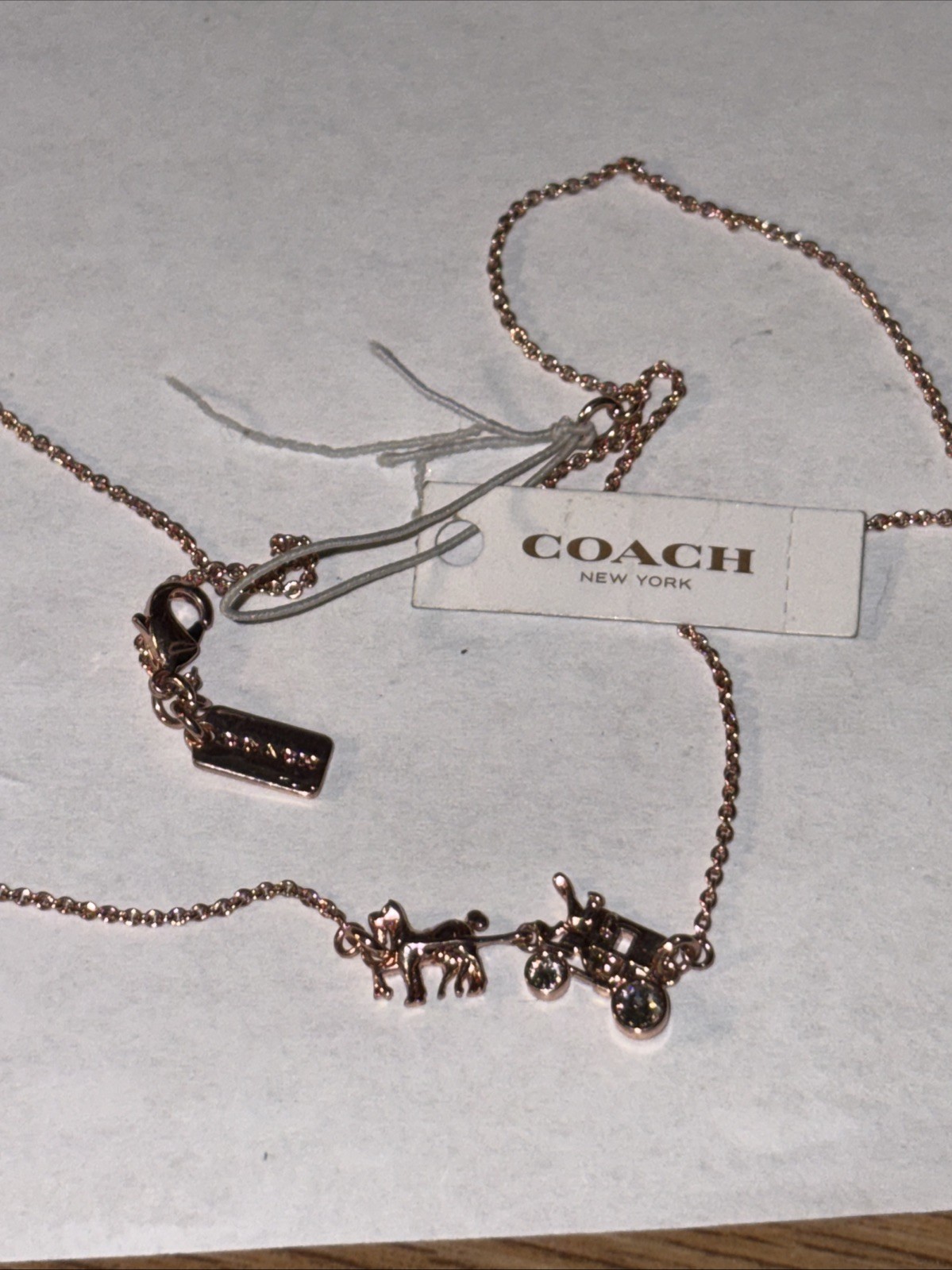 coach necklace 16 in cubic zorconia wheels on wagon, rose gold tone.