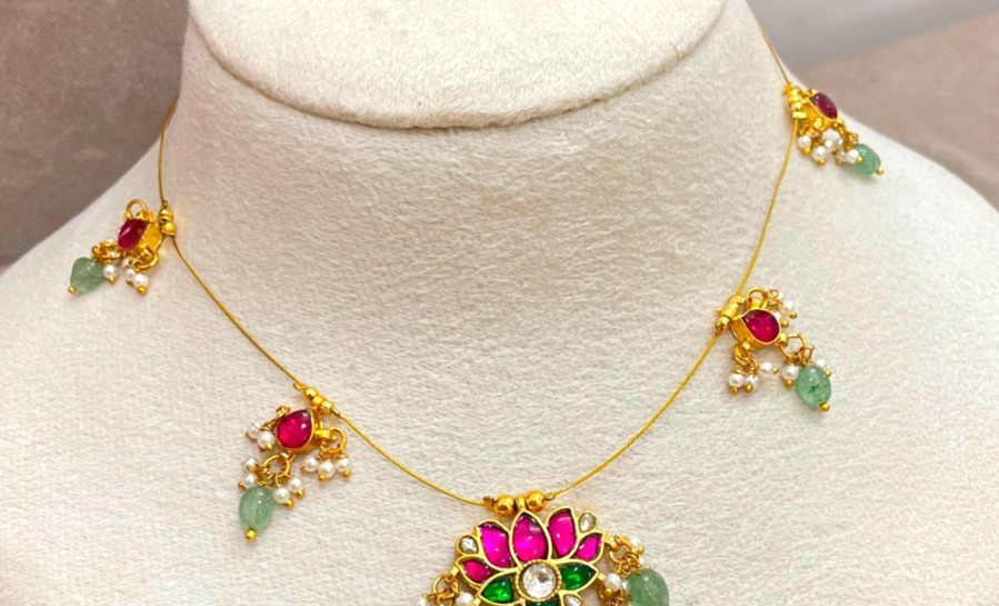 Brass jadau invisible necklace a central lotus pendant with pink and green stone