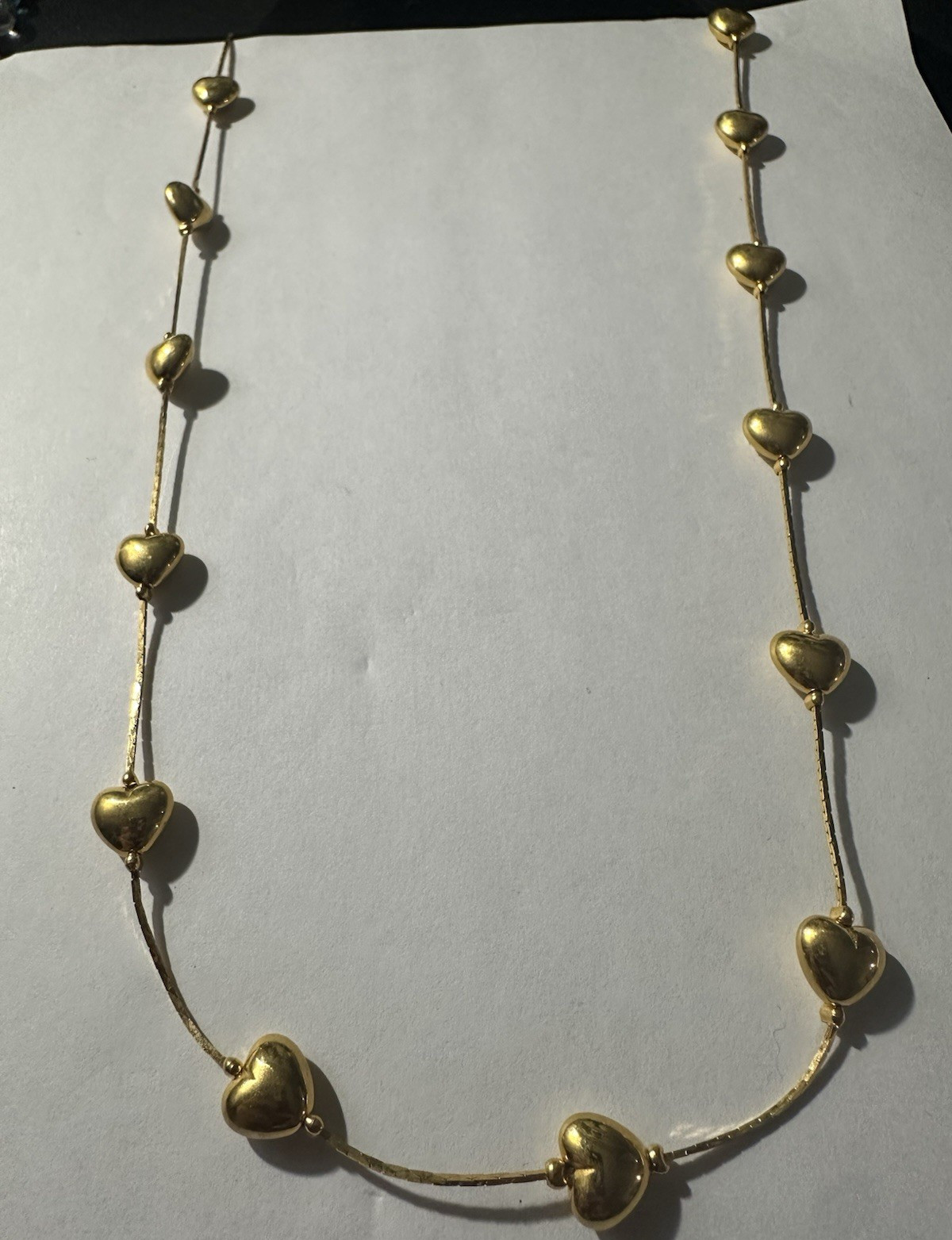 Trifari gold-tone chain features multiple stationed puffy hearts