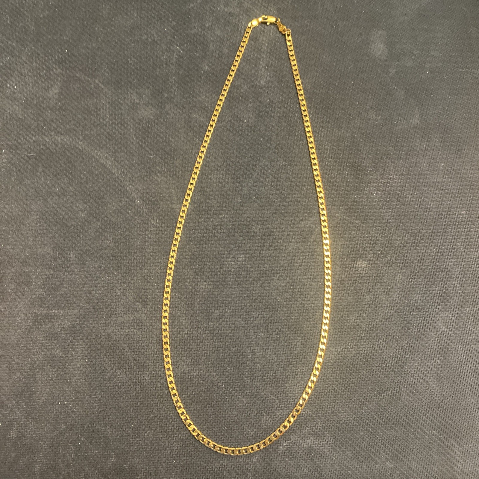 Cuban link chain necklace, gold in color. 23 inches long.