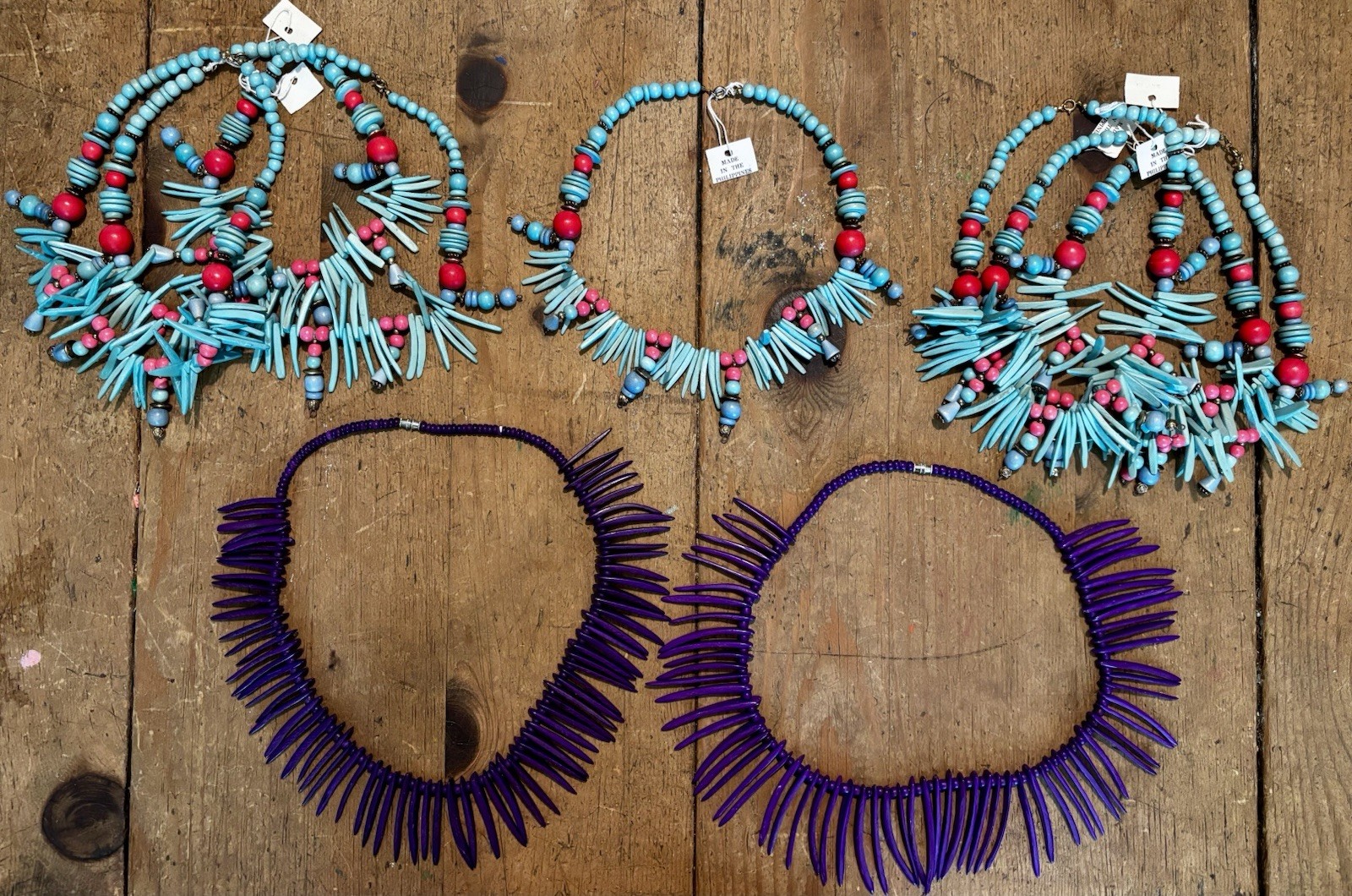 7 Blue Red Beaded Statement Bib Necklaces, 2 purple wooden necklaces. 9 total.