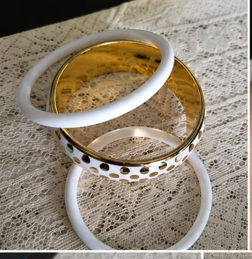A modern and elegant bracelet set consisting of three white bracelets with gold