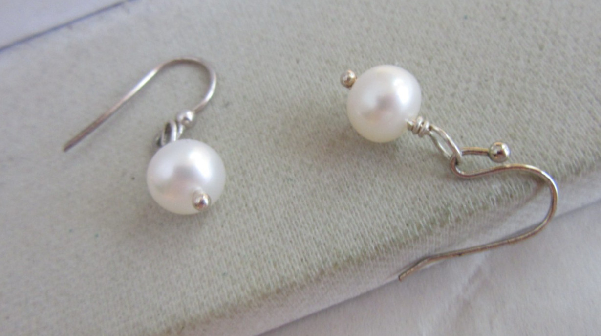 Silver tone hook pierced earrings with a white pearl charm