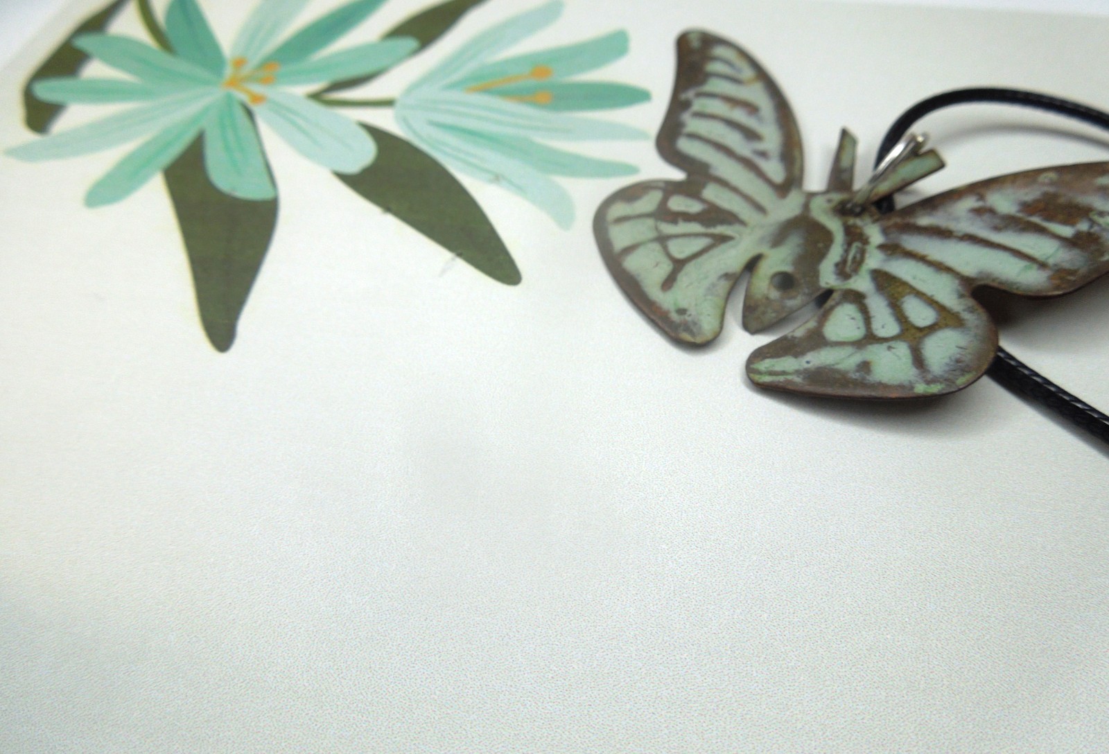 oxidized copper butterfly pendant on black faux leather cord upcycled
