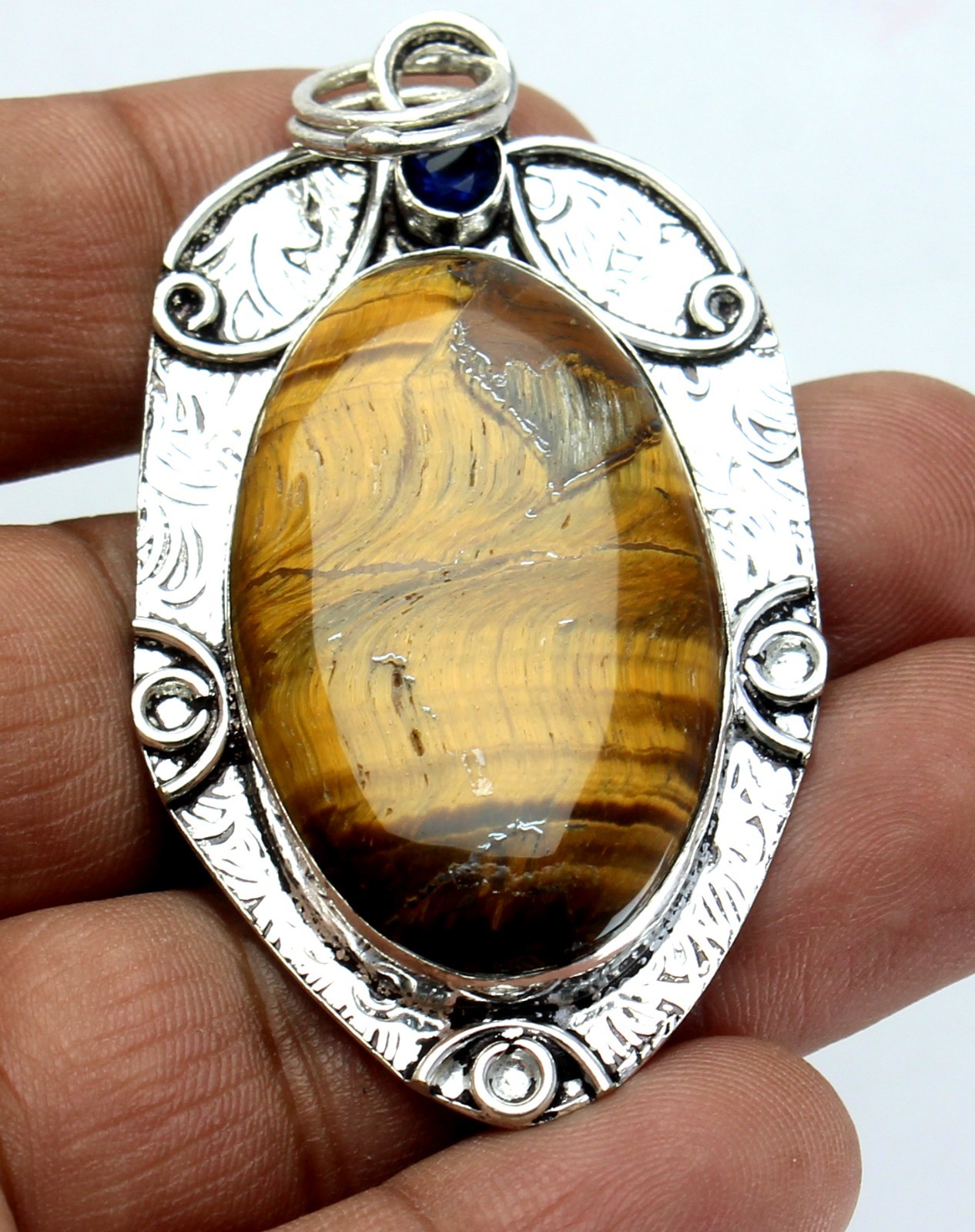 Handcrafted Sterling Silver Natural Tiger’s Eye Pendant – Blue Sapphire Accent